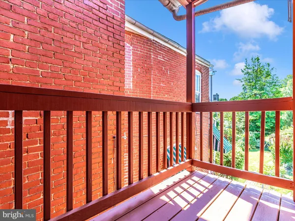 a brick building with a bench and a window