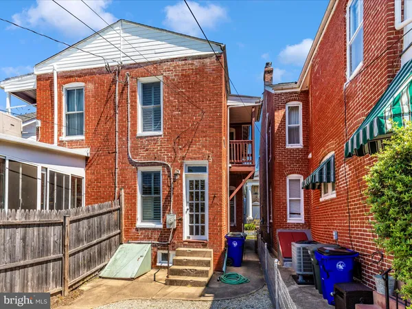 a view of a backyard with wooden fence
