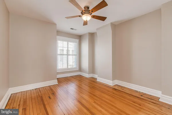 a kitchen with stainless steel appliances granite countertop hardwood floor sink stove and wooden cabinets