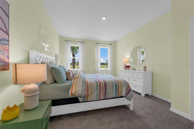 a spacious bedroom with a bed and window