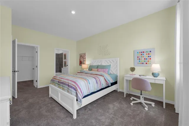 a spacious bedroom with a bed and a chair