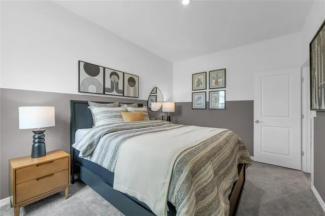 a bedroom with a bed and a lamp on table