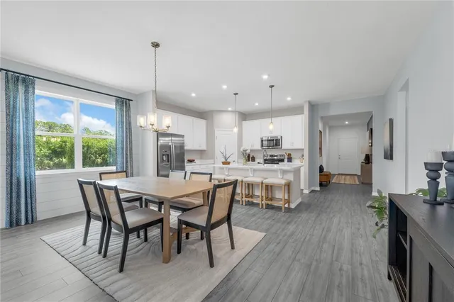 a dining room with furniture and window
