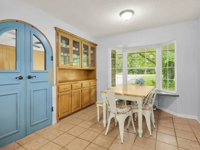 a kitchen with white cabinets and appliances