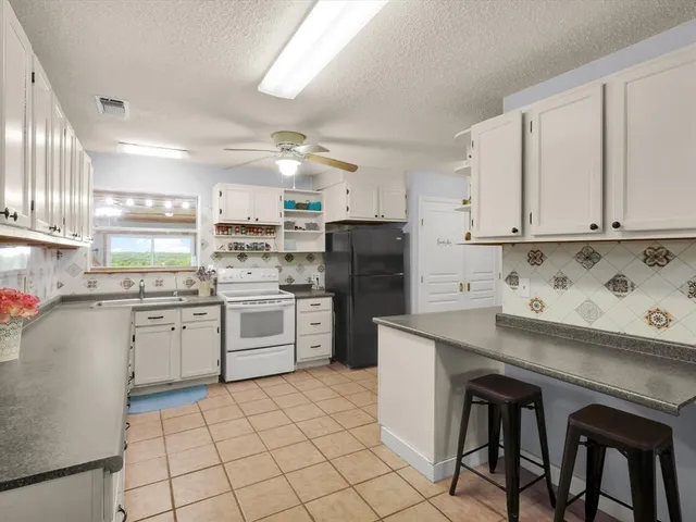 a kitchen with cabinets and window