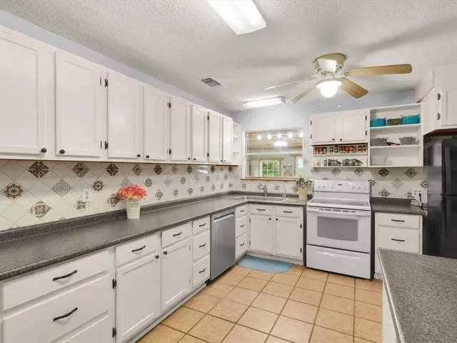 a kitchen with stainless steel appliances granite countertop a sink and cabinets