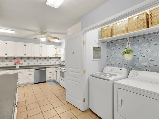 a spacious bedroom with a bed couch and window