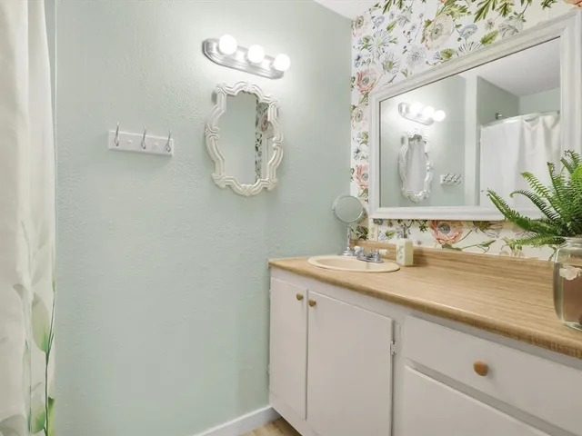 a view of a livingroom with wooden floor and furniture