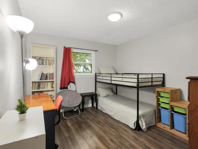 a bedroom with a bed and chair