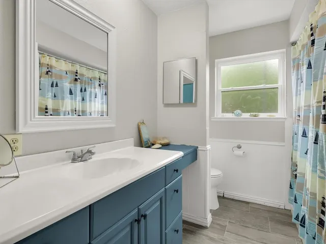 a view of a workspace with furniture and a chandelier