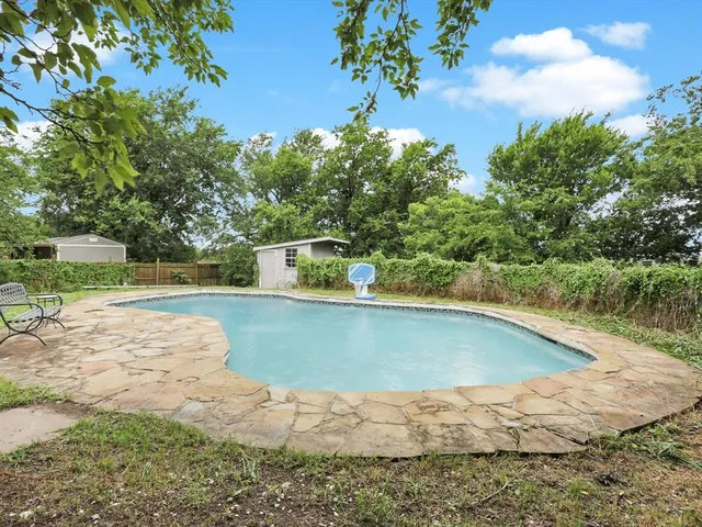 a view of a swimming pool with a yard