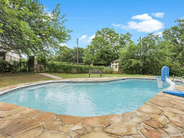 a view of a swimming pool with a yard