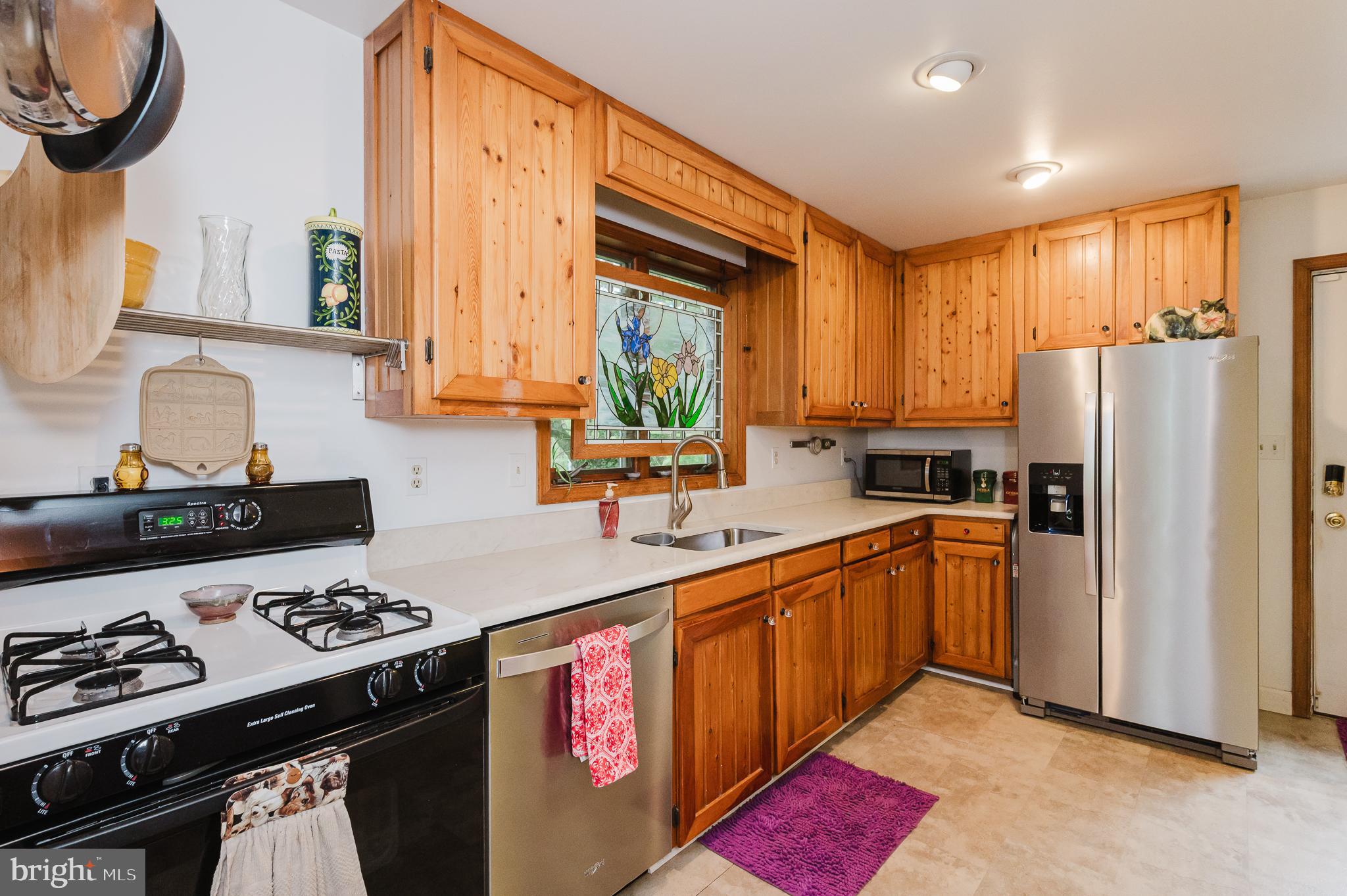 710 Magnolia Road Joppa, MD 21085 - Photo 8 of 58 a kitchen with stainless steel appliances a stove a sink and a refrigerator