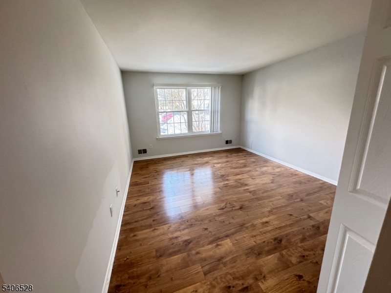 15 Hanover Square, Unit C Middlesex, NJ 08846 - Photo 2 of 12 a view of empty room with wooden floor and fan