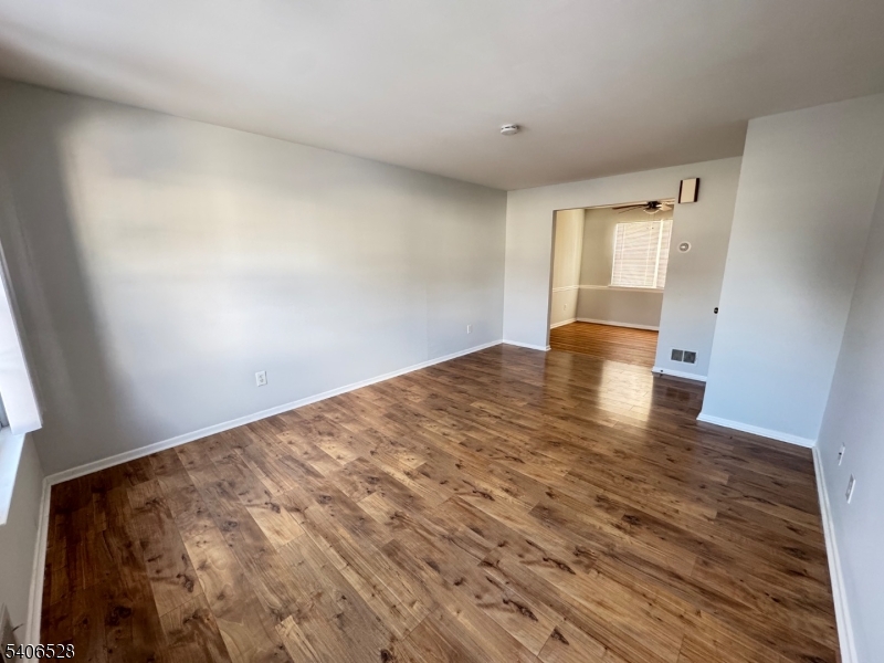 15 Hanover Square, Unit C Middlesex, NJ 08846 - Photo 4 of 12 a view of empty room with wooden floor
