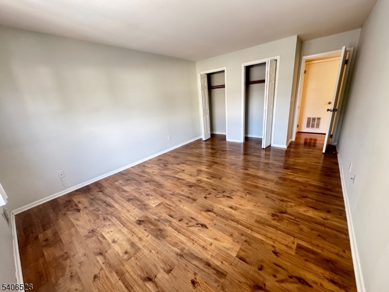 15 Hanover Square, Unit C Middlesex, NJ 08846 - Photo 5 of 12 a view of empty room with wooden floor and fan