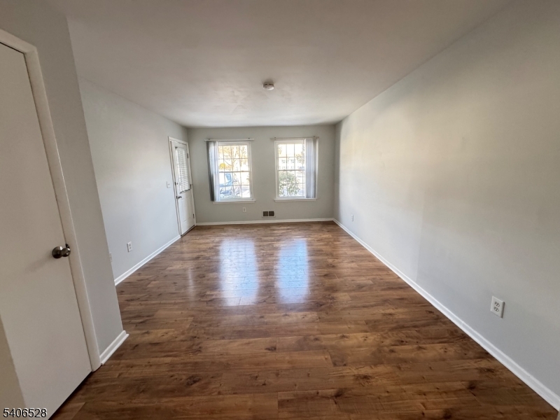 15 Hanover Square, Unit C Middlesex, NJ 08846 - Photo 9 of 12 an empty room with wooden floor and windows