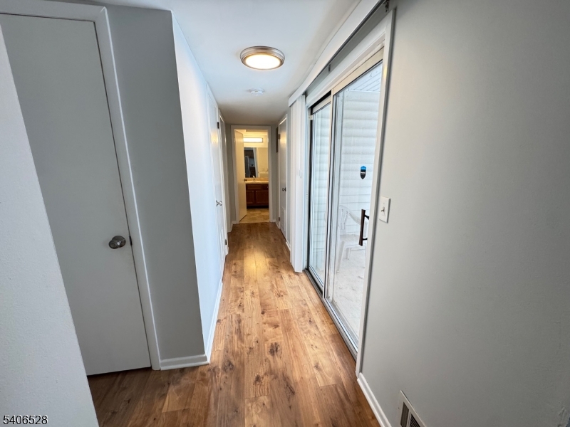 15 Hanover Square, Unit C Middlesex, NJ 08846 - Photo 10 of 12 a view of a hallway with wooden floor and staircase