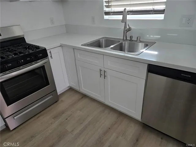 a kitchen with sink a microwave and stove