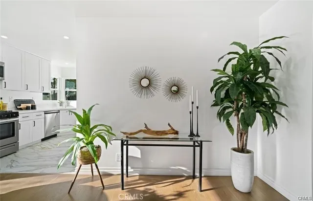 a view of a dining room with furniture and a potted plant