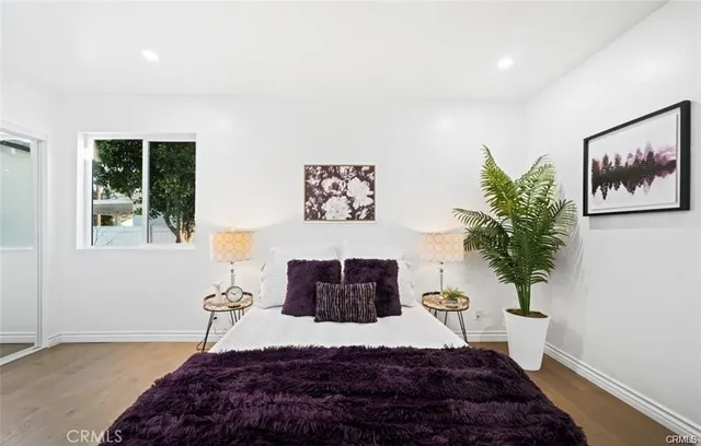 a bedroom with a bed and a potted plant