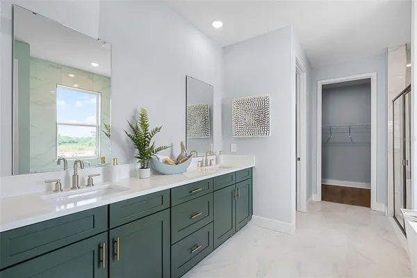 a bathroom with a double vanity sink and a mirror