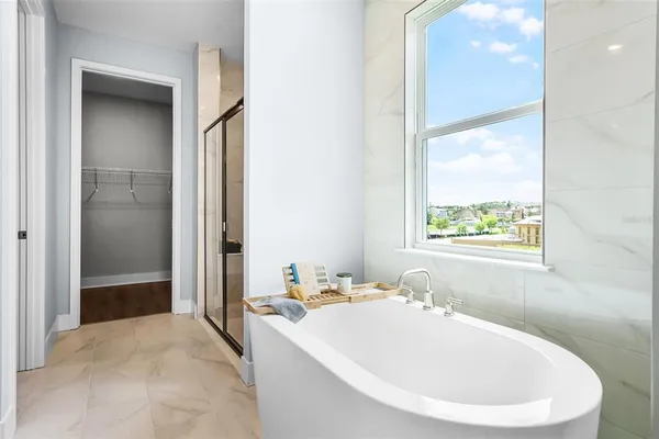 a white bath tub sitting next to a white sink