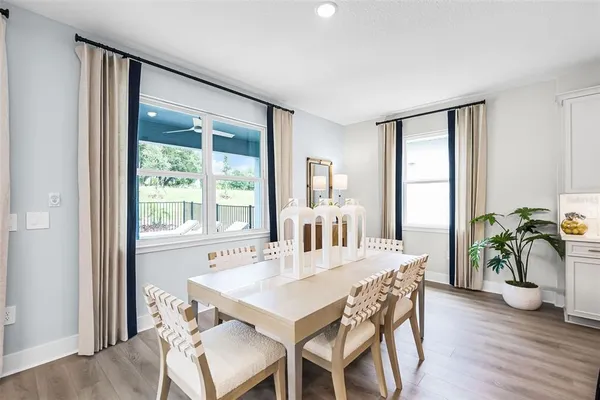 a view of a dining room with furniture window and wooden floor