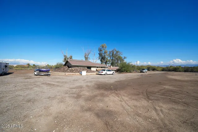 a view of a yard with wooden fence
