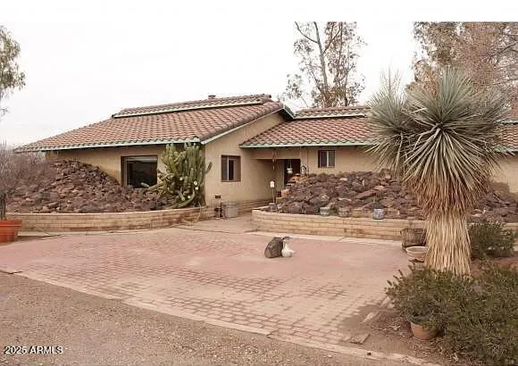 a front view of a house with yard porch and furniture