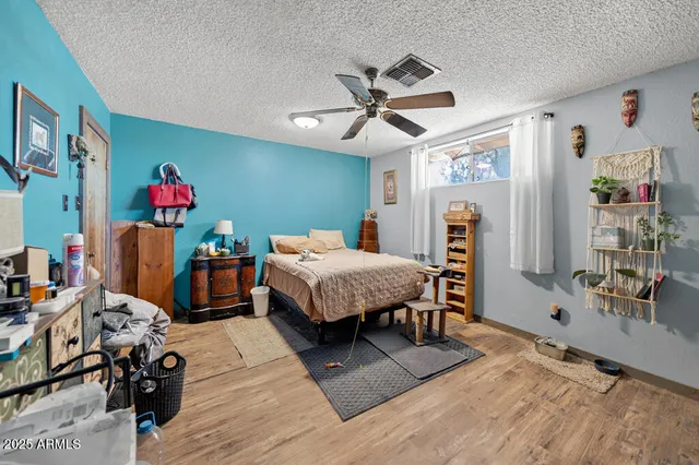 a bedroom with furniture and a flat screen tv