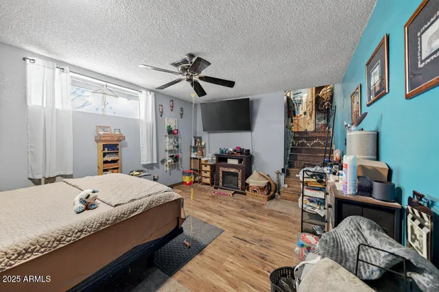 a bedroom with furniture and a flat screen tv