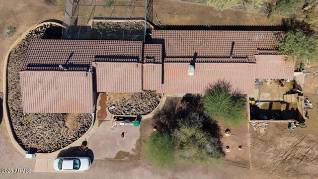 a roof deck with table and chairs a fire pit and grass