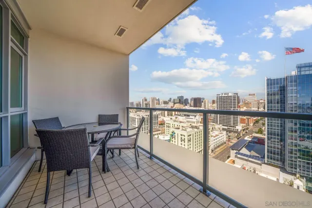 a view of a balcony with table and chairs