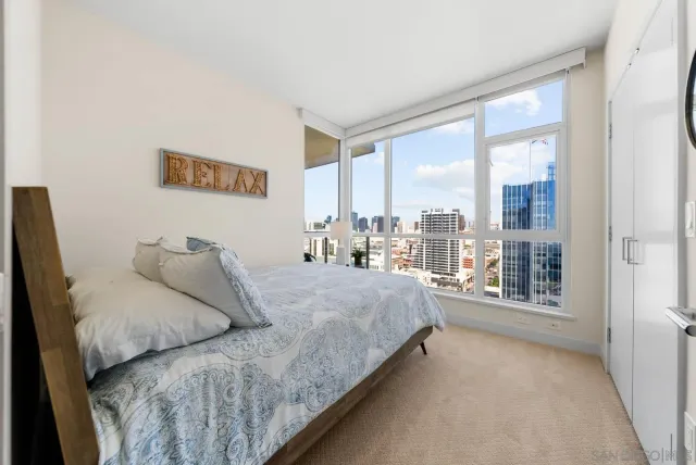 a bedroom with a large bed and a large window