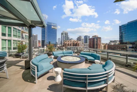 a view of a patio with couches chairs and a potted plant