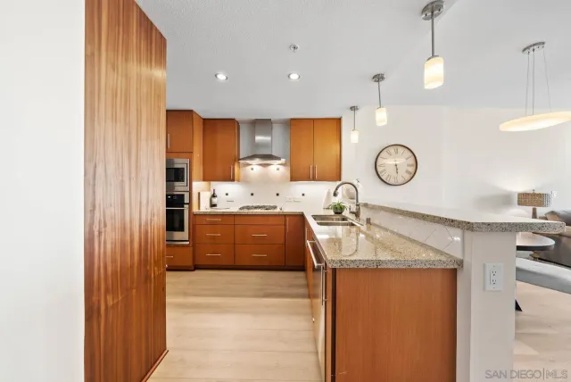 a large kitchen with a sink a refrigerator and a stove