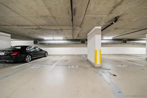 a view of parking garage with cars parked