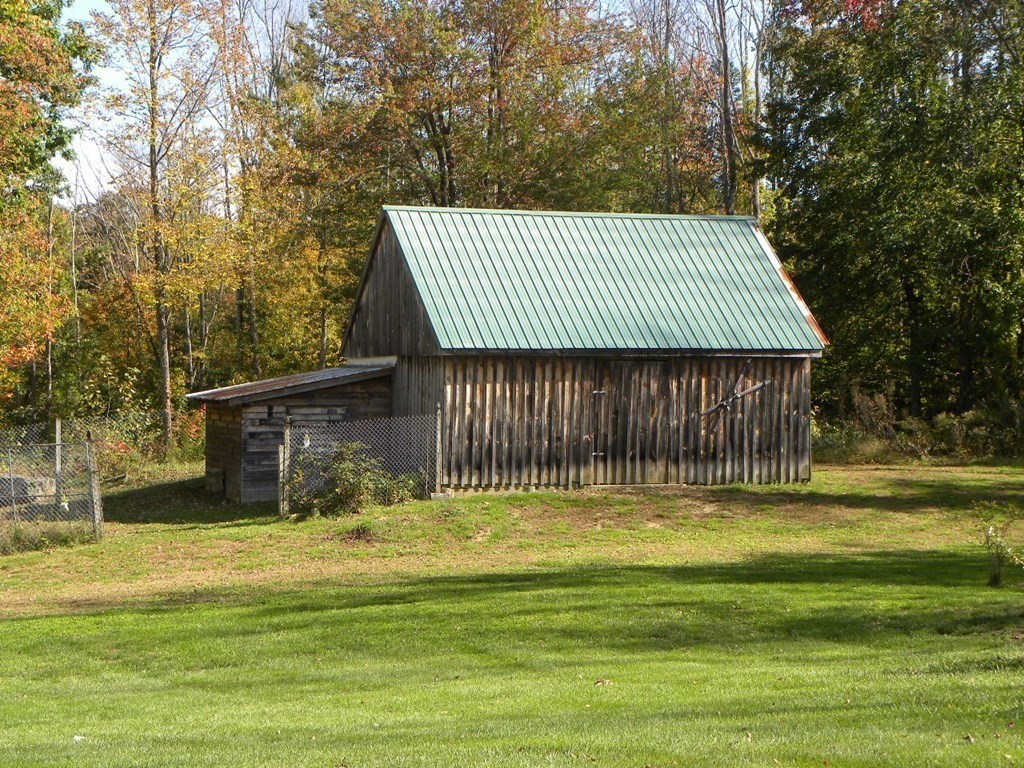 360 Coldbrook Road Oakham, MA 01068 - Photo 24 of 28 a view of a house with a yard