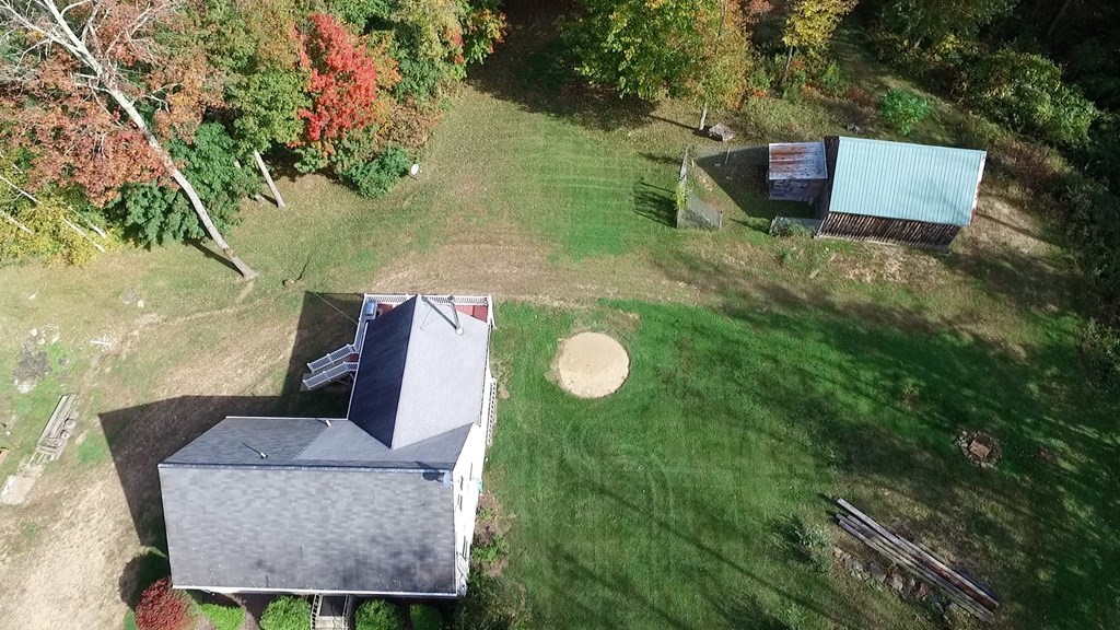 360 Coldbrook Road Oakham, MA 01068 - Photo 27 of 28 a backyard of a house with table and chairs