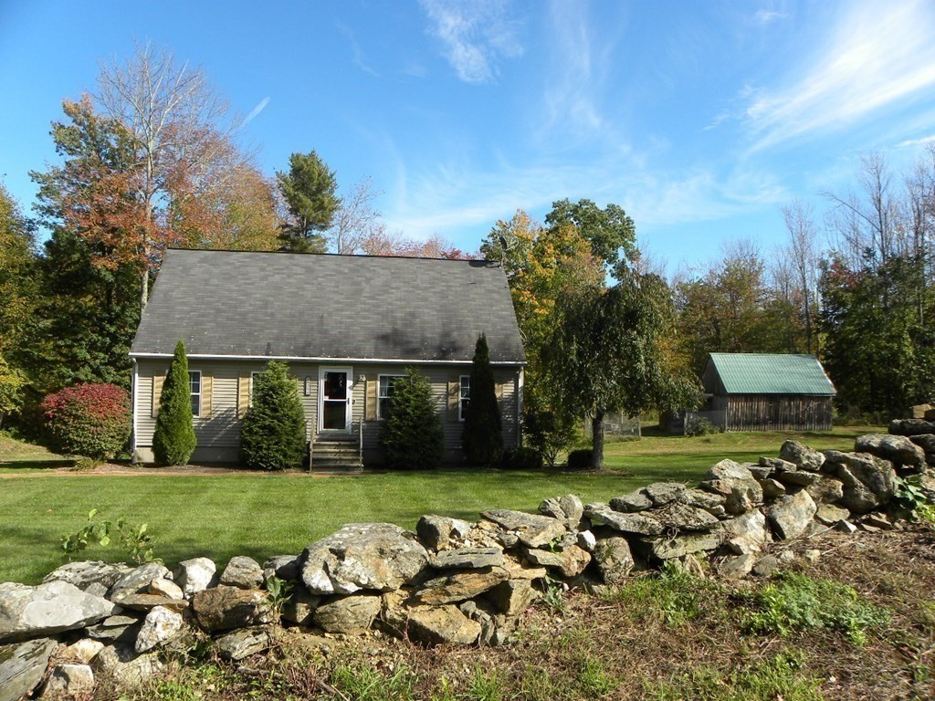 360 Coldbrook Road Oakham, MA 01068 - Photo 3 of 28 front view of a house with a yard