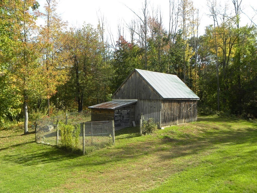 360 Coldbrook Road Oakham, MA 01068 - Photo 4 of 28 a backyard of a house with table and chairs