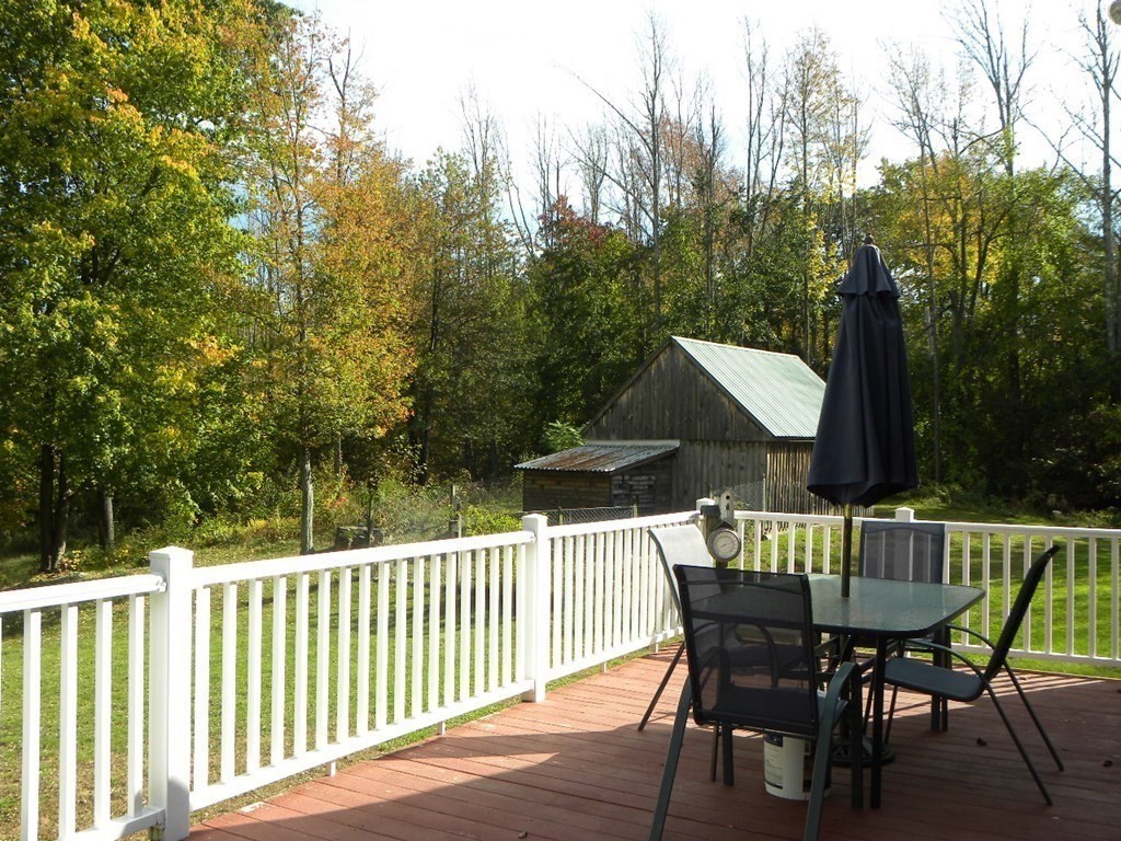 360 Coldbrook Road Oakham, MA 01068 - Photo 6 of 28 a view of a wooden chairs and table in the deck