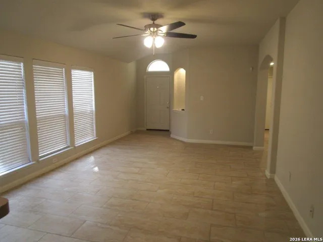 an empty room with windows and entrance