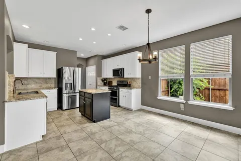 a kitchen with refrigerator and window