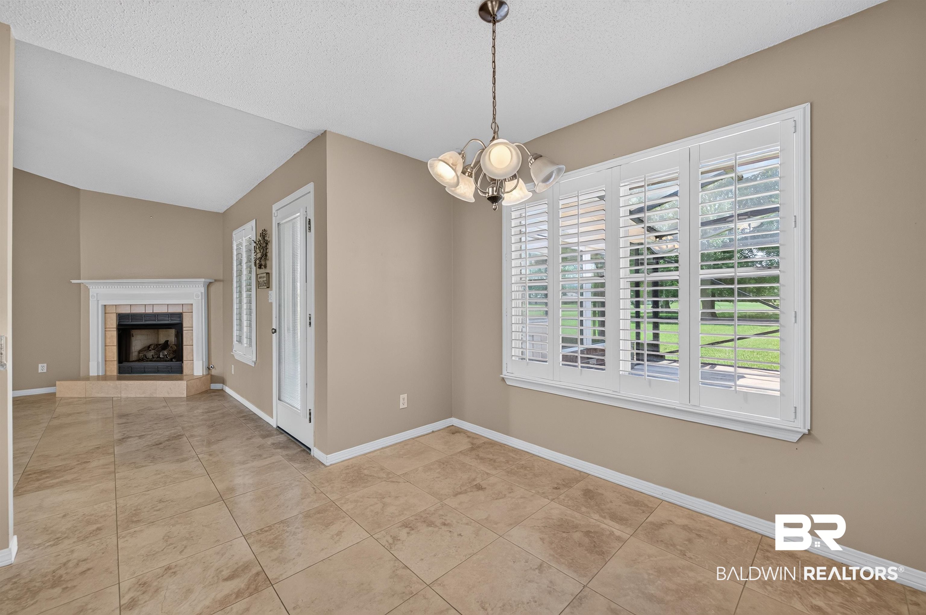 22685 County Road 12 Foley, AL 36535 - Photo 40 of 89 Spacious room with large window featuring white plantation shutters and a view of the exterior