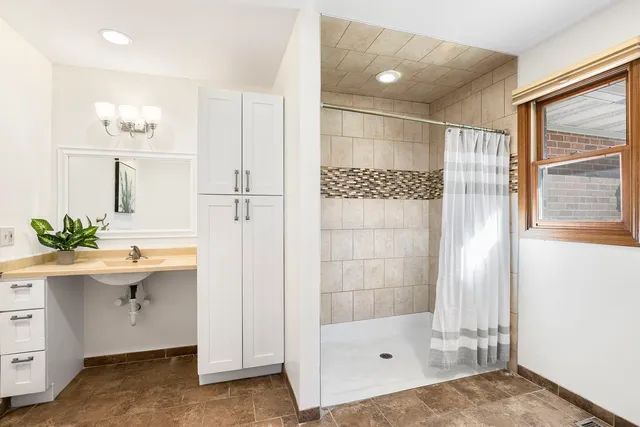 a bathroom with a shower and a sink