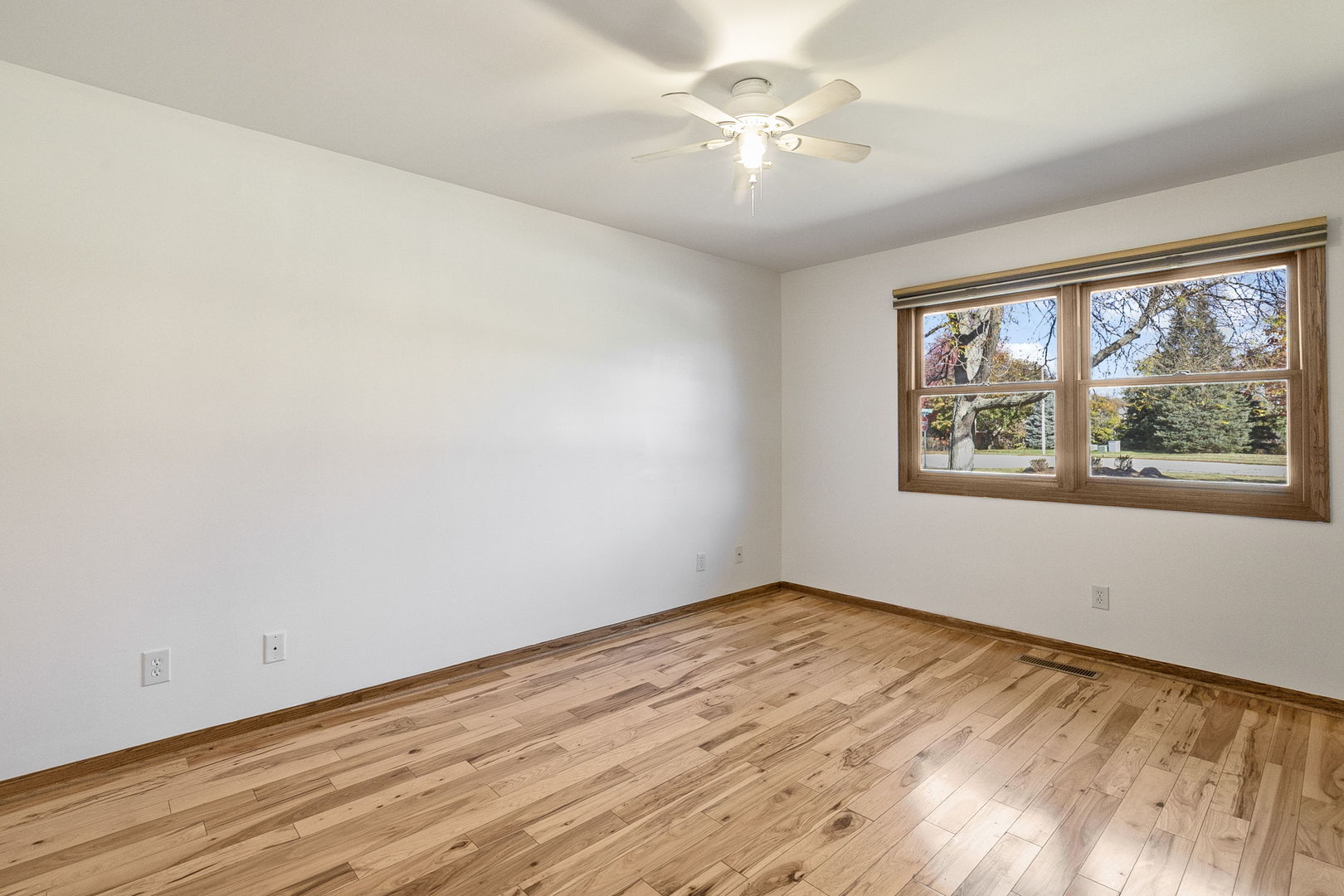 10201 Fox Bluff Lane Spring Grove, IL 60081 - Photo 14 of 26 wooden floor in an empty room with a window