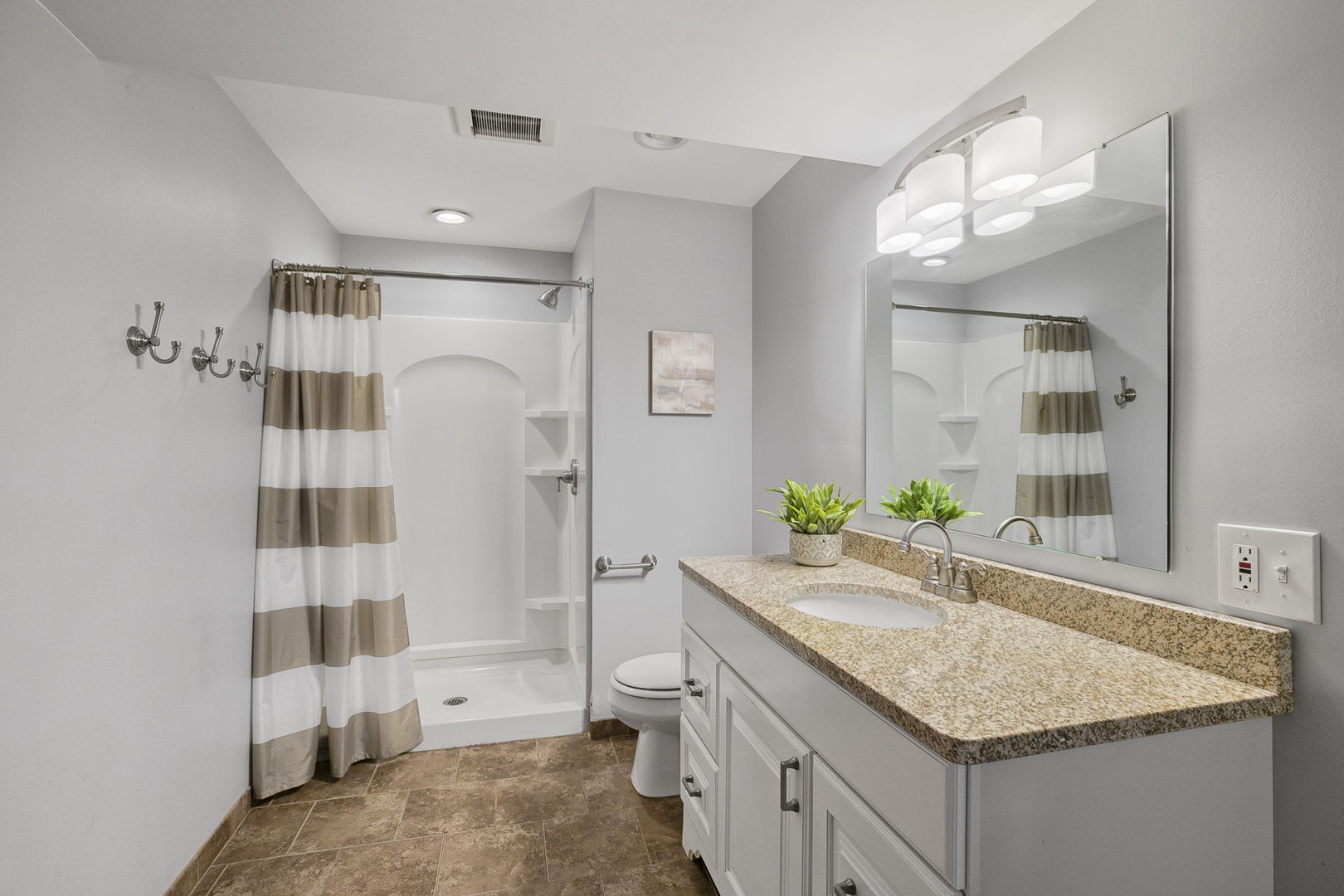 10201 Fox Bluff Lane Spring Grove, IL 60081 - Photo 20 of 26 a bathroom with a granite countertop sink a toilet a shower and a mirror