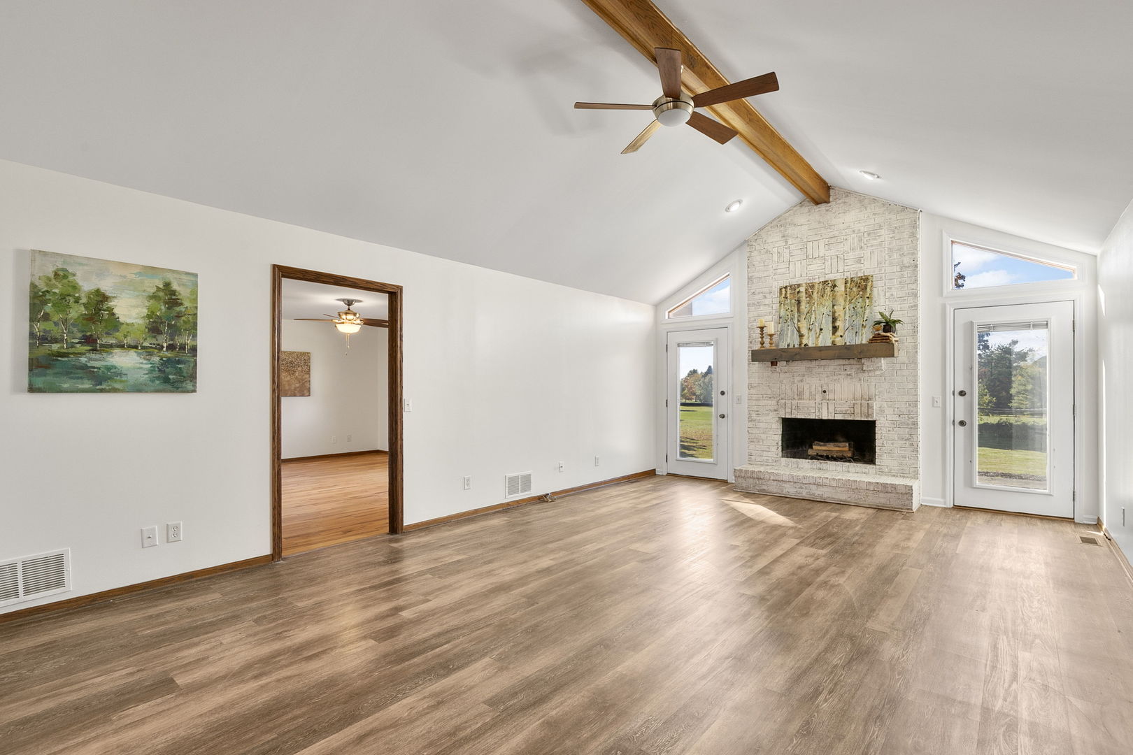 10201 Fox Bluff Lane Spring Grove, IL 60081 - Photo 2 of 26 a view of a livingroom with wooden floor a fireplace and window
